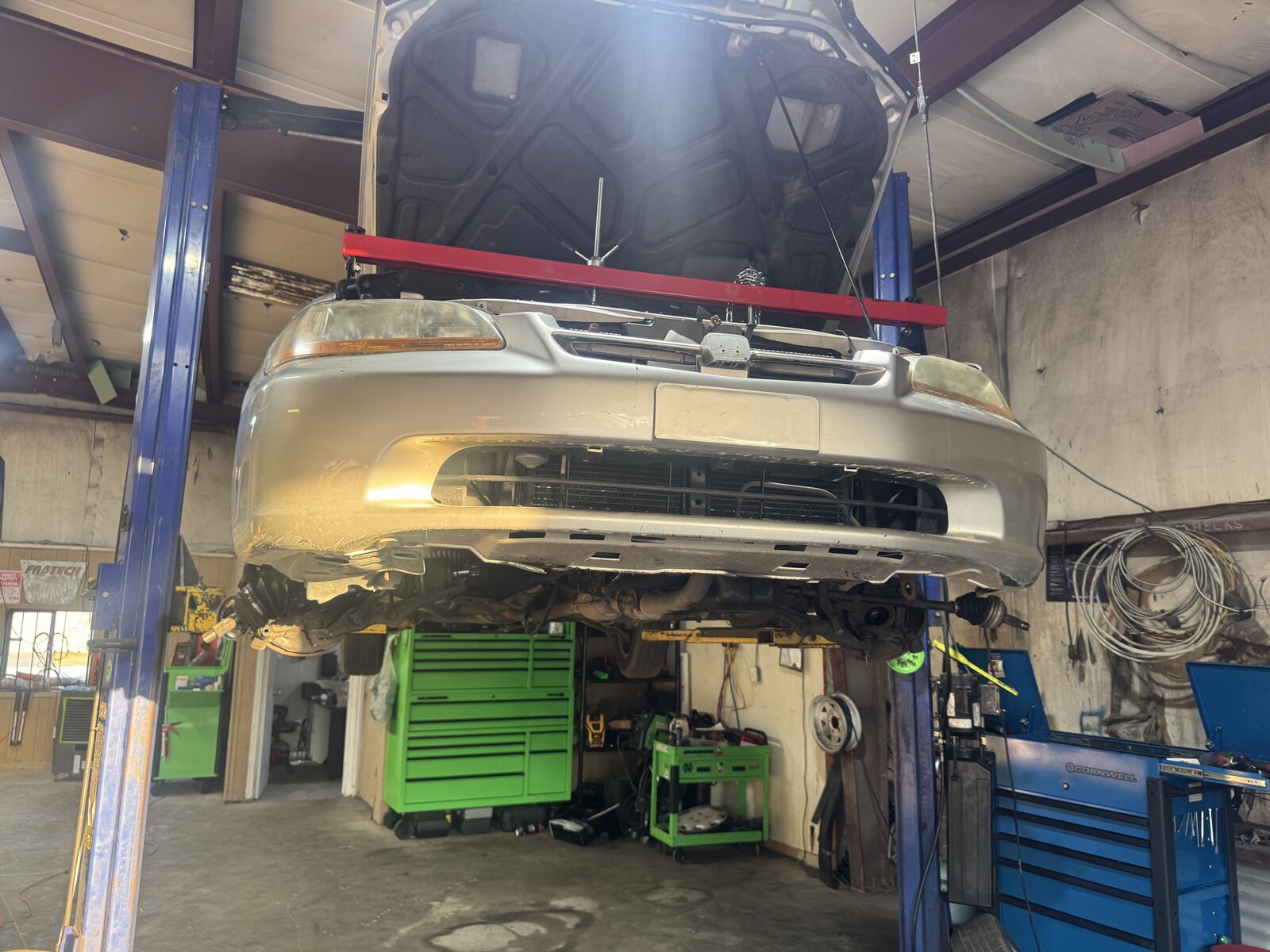 Car on lift inside Bundy's Tire & Auto Repair shop in Fayetteville